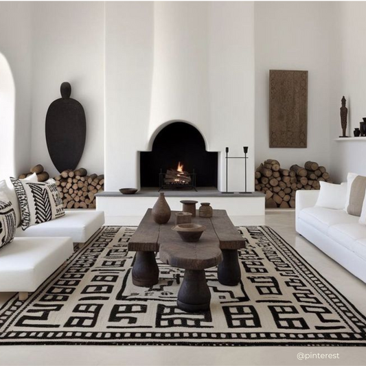African living room with a raw table and a rug with geometric patterns.